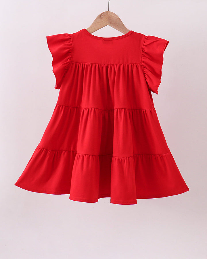 Red dress with ruffled sleeves on a hanger against a white background