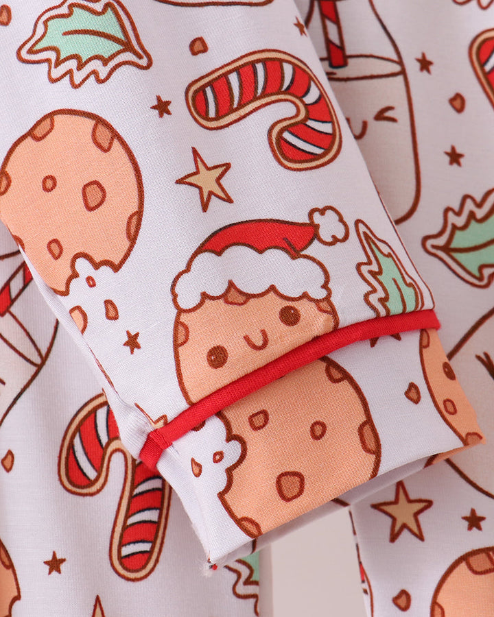 Close-up of pajama cuff with red trim on cookie-print fabric