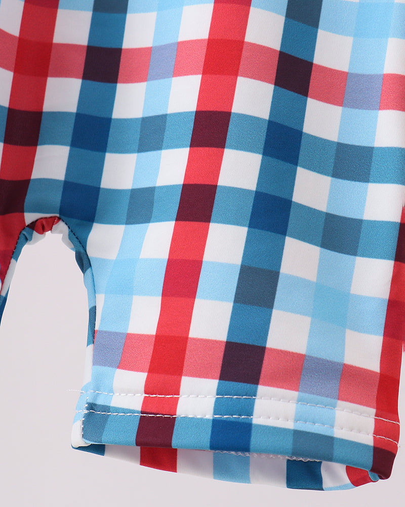 Close-up of a red, blue, and white checkered fabric on a light gray background