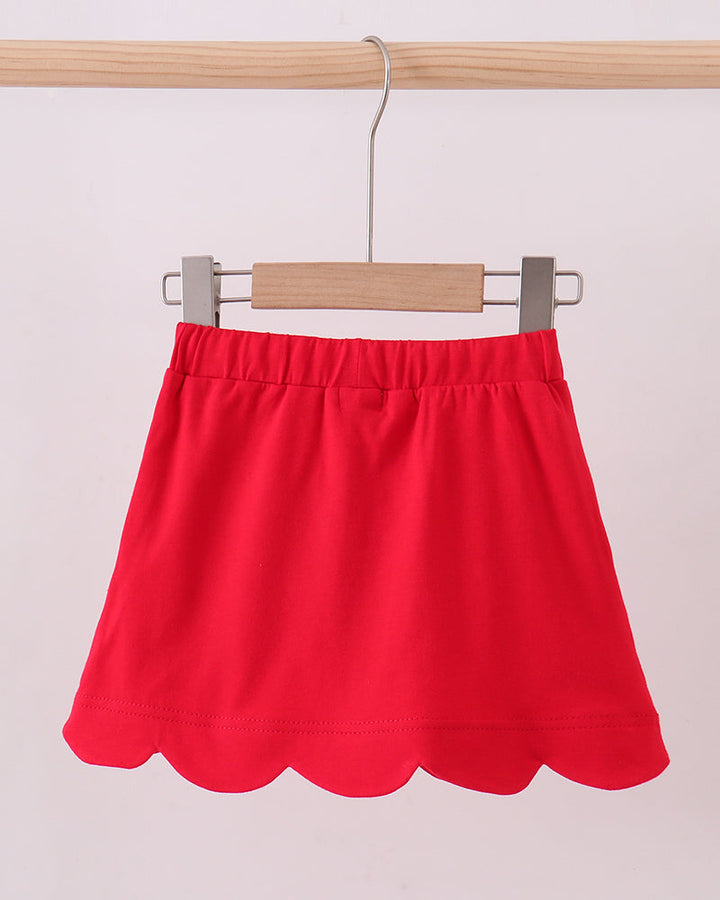 Red skort on hanger with scalloped hem and gathered elastic waistband