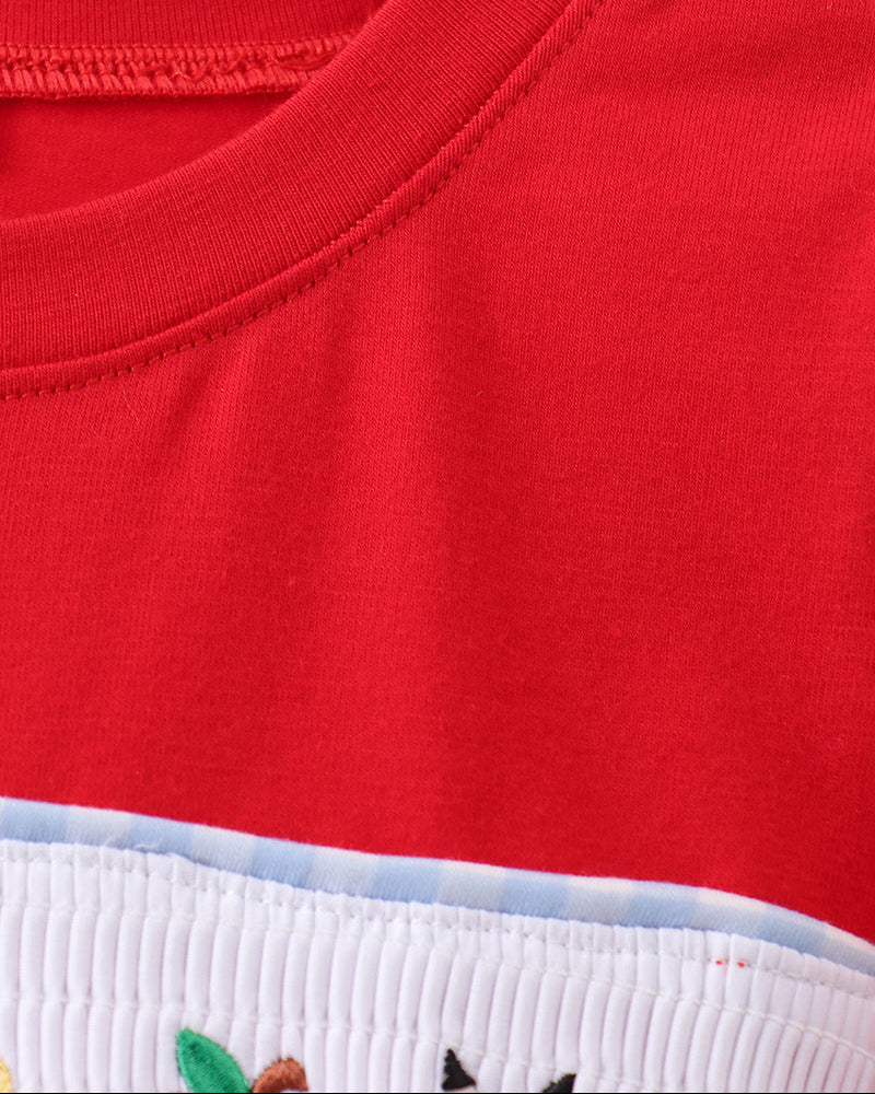 Red kids T-shirt with white smocked band and colorful applique edge