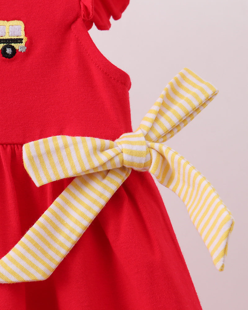 Red dress with yellow striped bow tie at waist