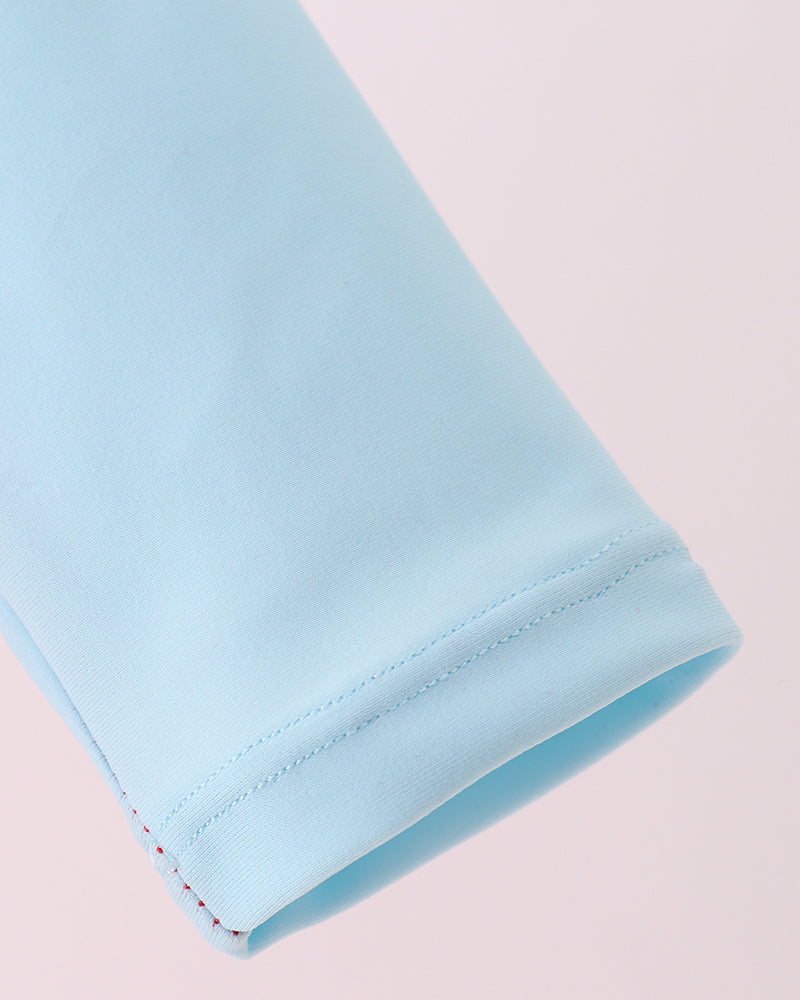 Light blue fabric roll on a light pink background