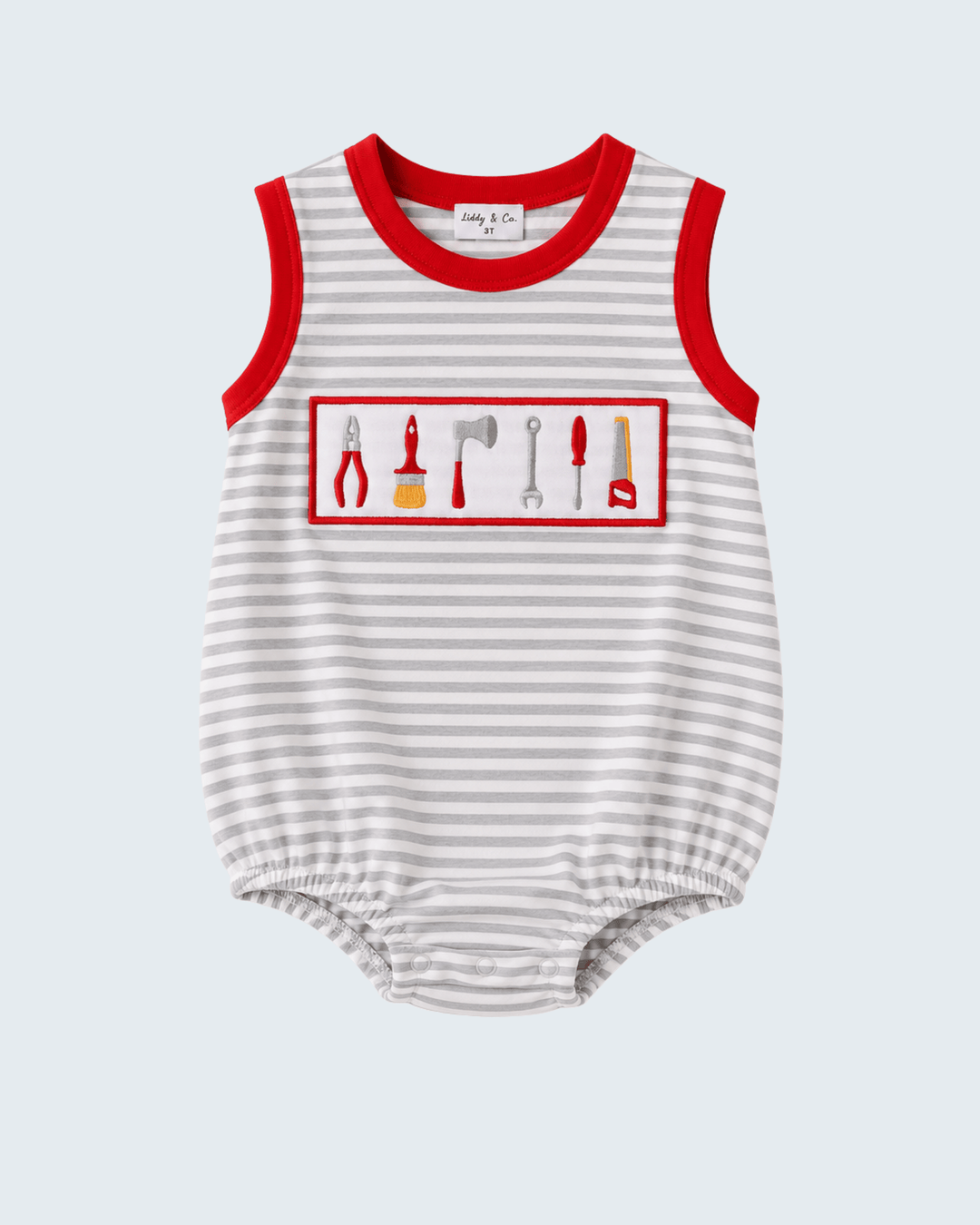 A sleeveless baby romper with thin gray and white horizontal stripes, red trim at the collar and armholes, and a chest graphic showing various hand tools inside a red rectangular border.
