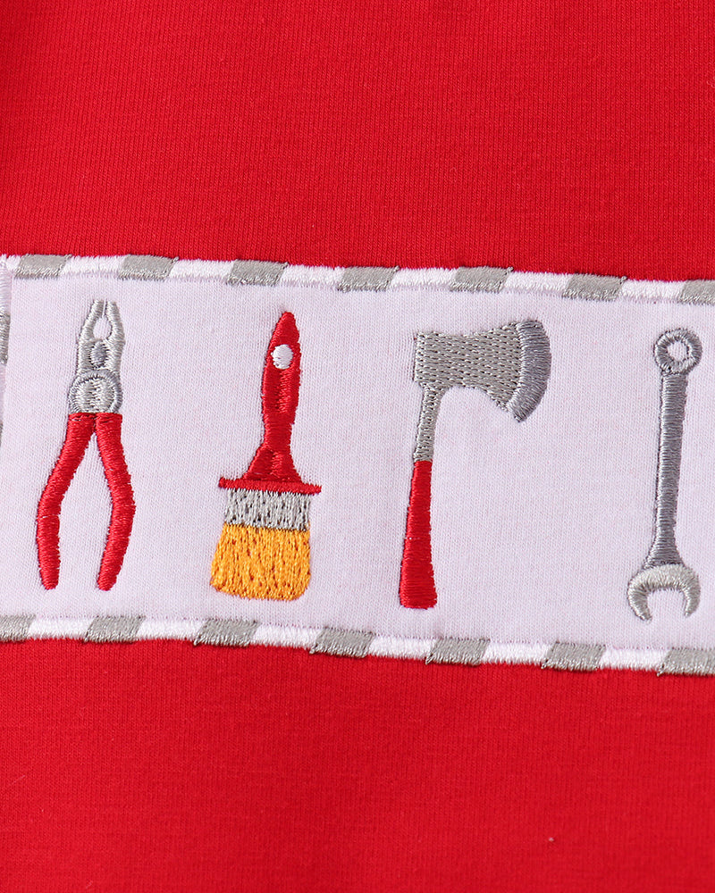 Red T-shirt with white toolbox-themed embroidery stripe across chest