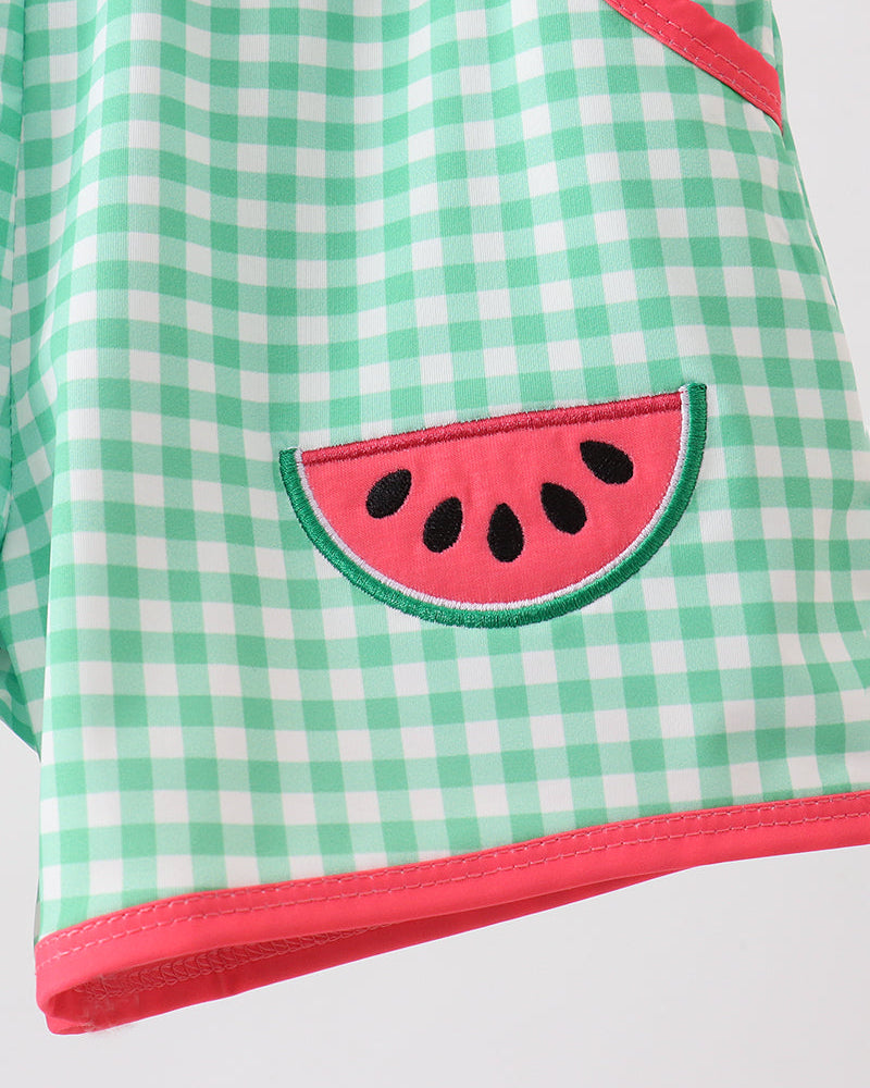 Green checkered shorts with a watermelon design on a white background