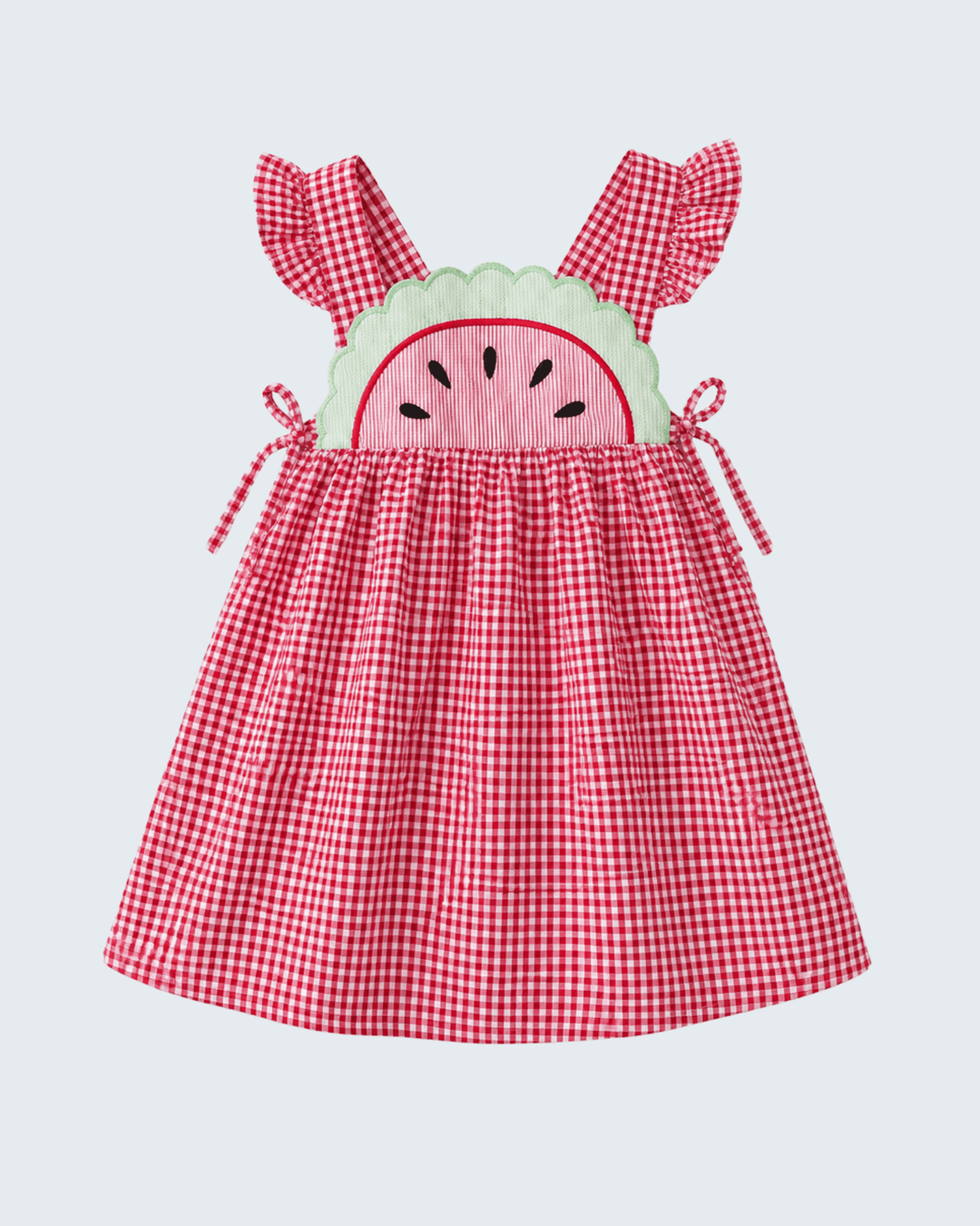 Red gingham dress with watermelon design on a light gray background