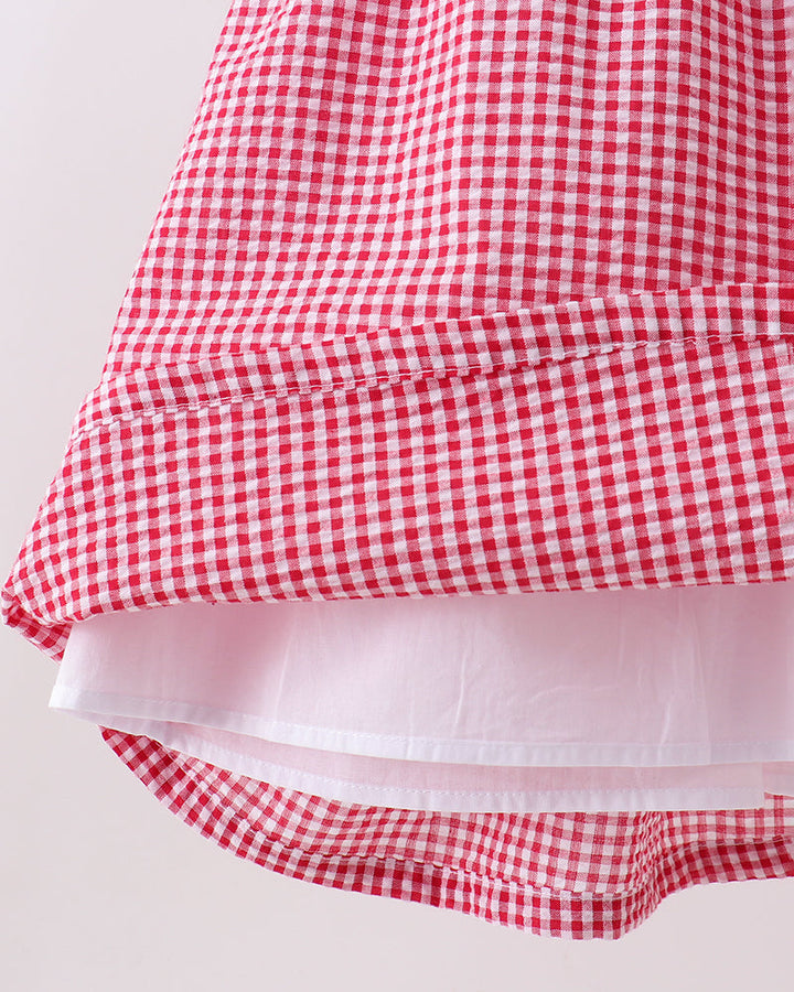 Red and white checkered fabric with a ruffled edge on a light background