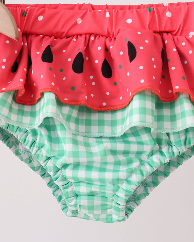 Two-piece children's swim set with red watermelon-themed top and green checkered bottom on a white background.