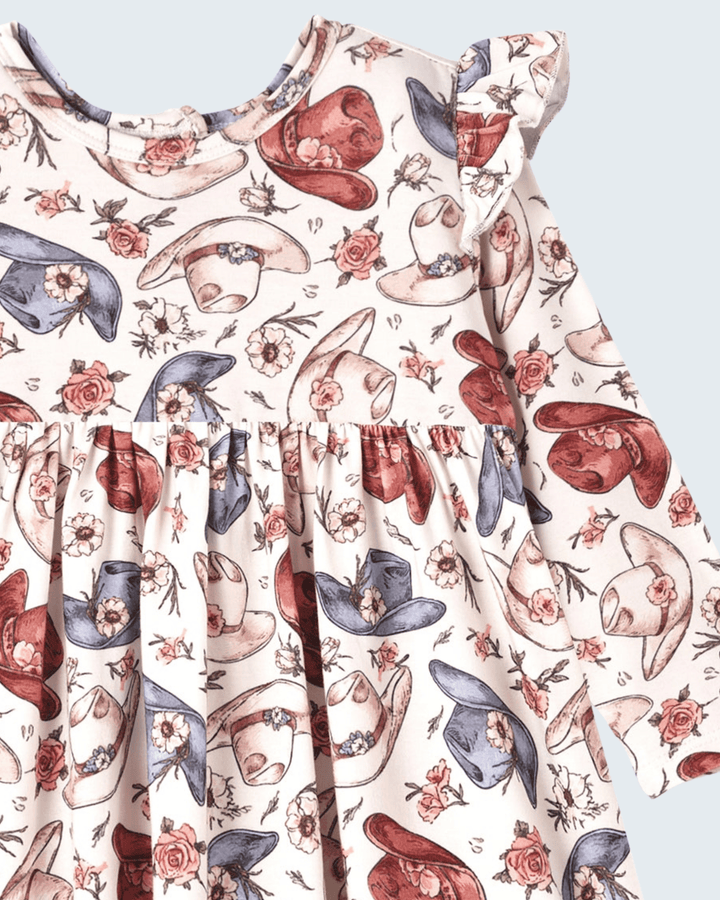 Cowgirl print bamboo dress with ruffled neckline and gathered skirt, hats and roses