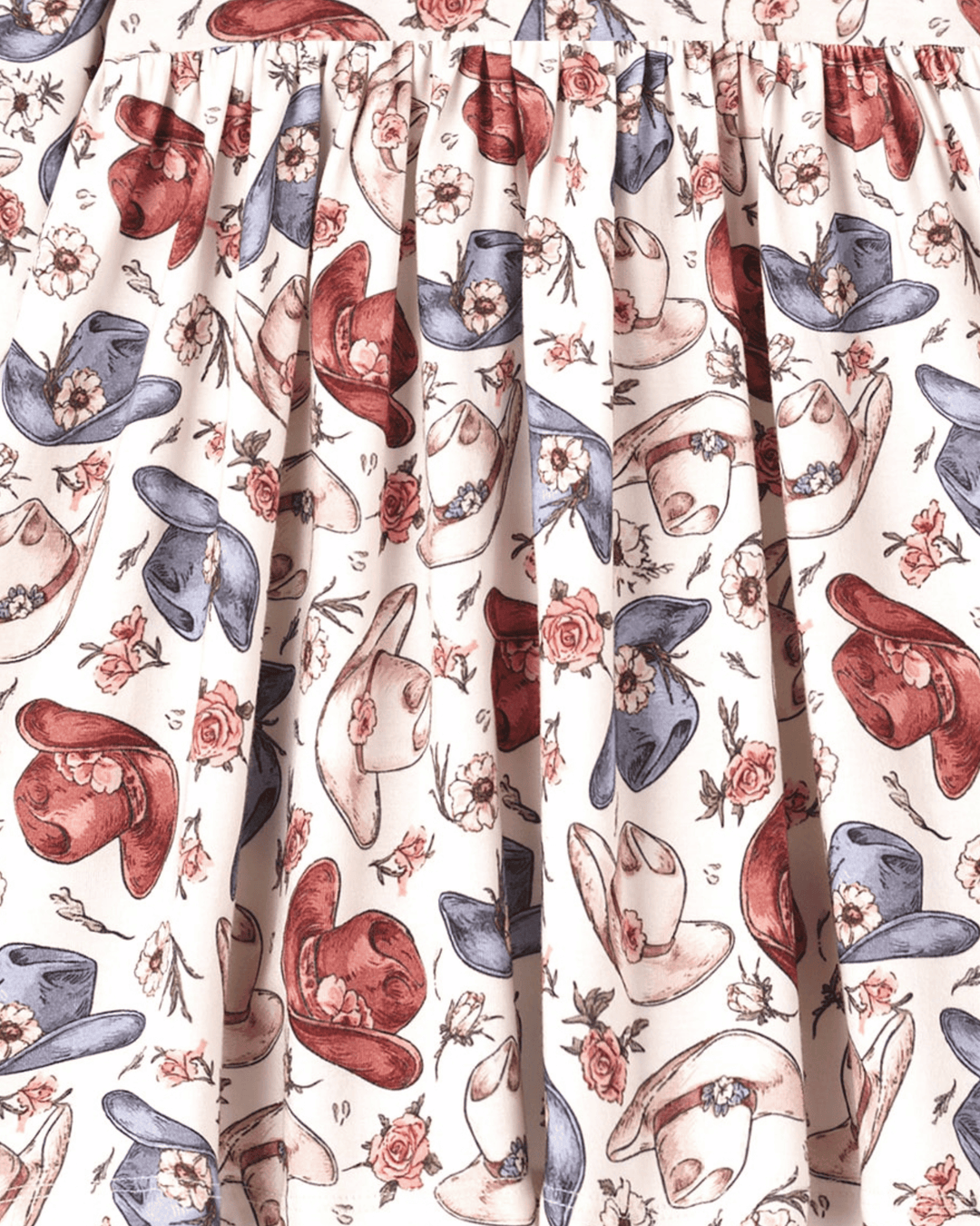 Cowgirl print bamboo dress fabric detail with cowboy hats, boots, and rose motifs