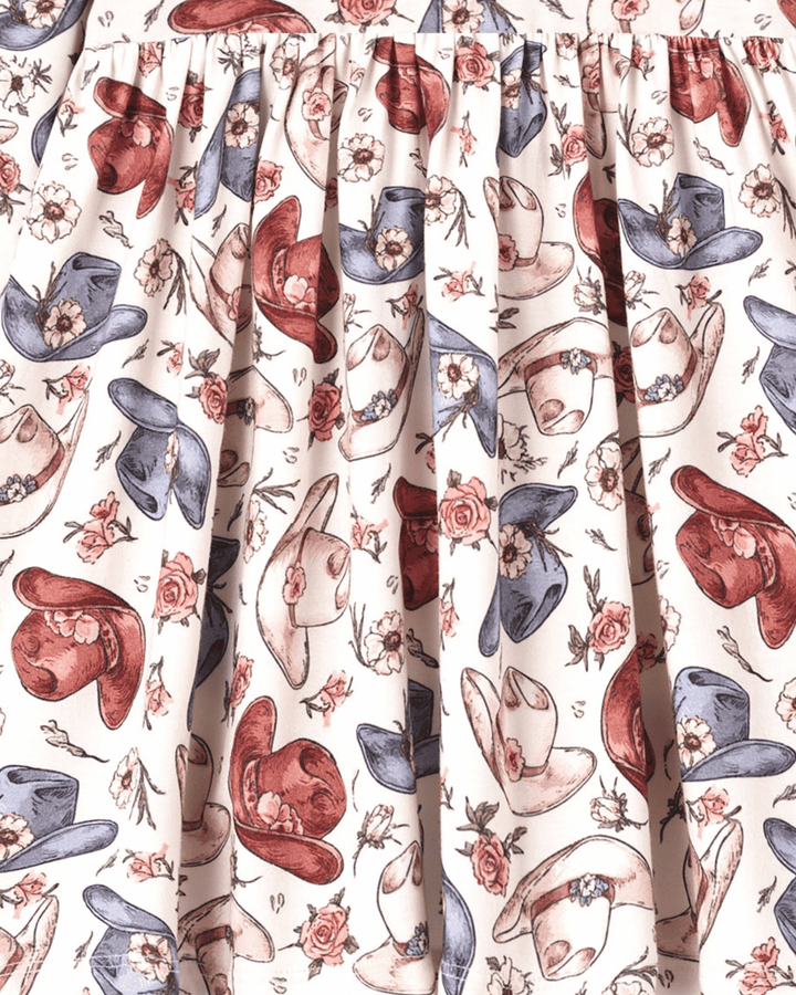 Cowgirl print bamboo dress fabric detail with cowboy hats, boots, and rose motifs