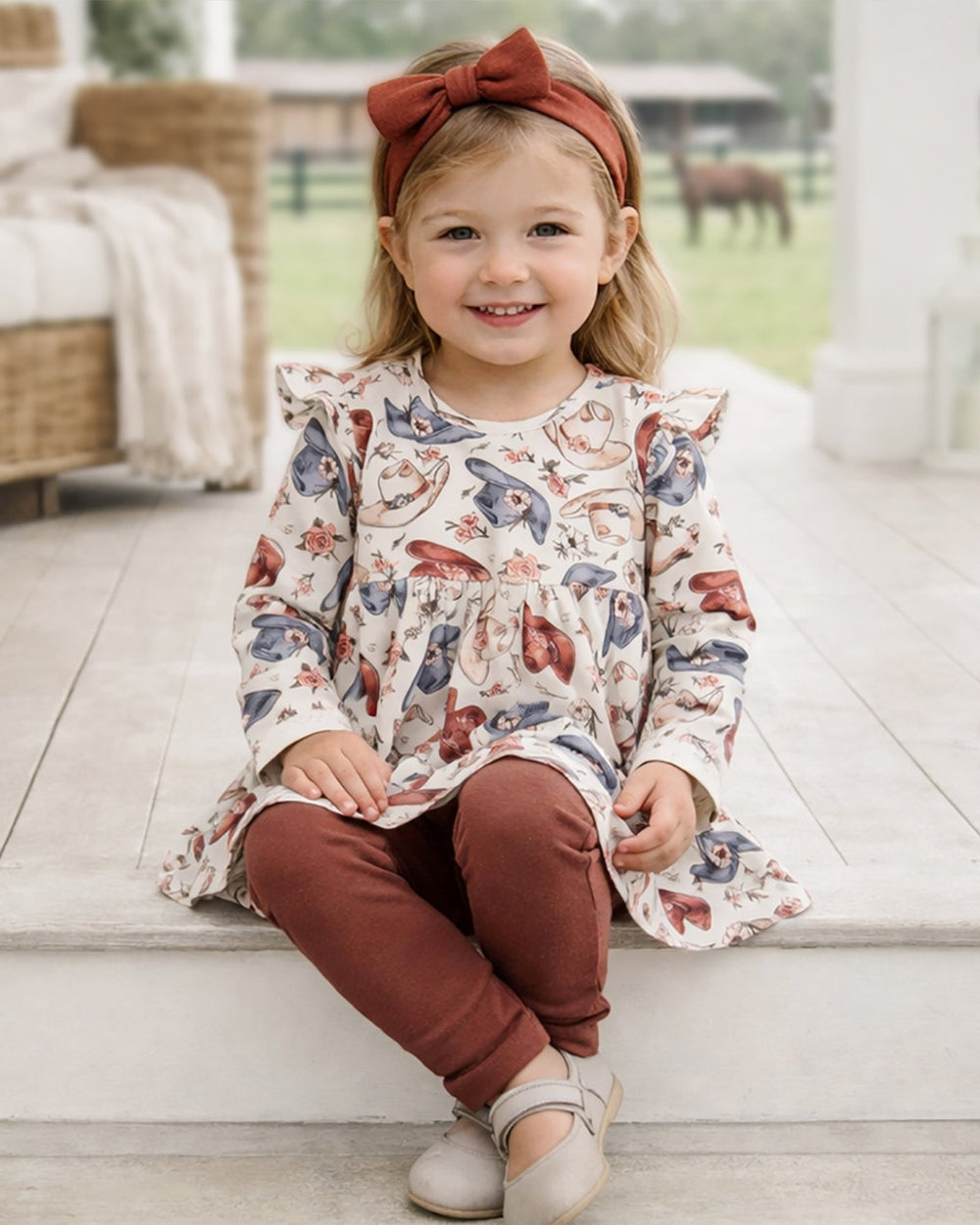 Girls cowgirl set: printed long-sleeve top and maroon leggings on model