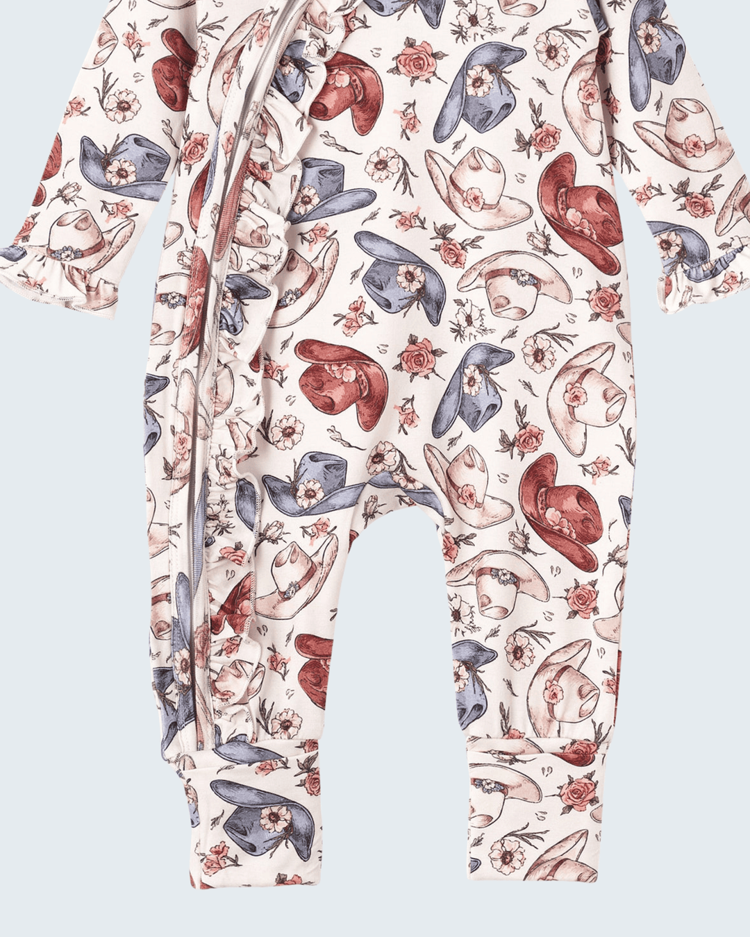 Bamboo zipper romper featuring cowboy hat and boot pattern on long legs