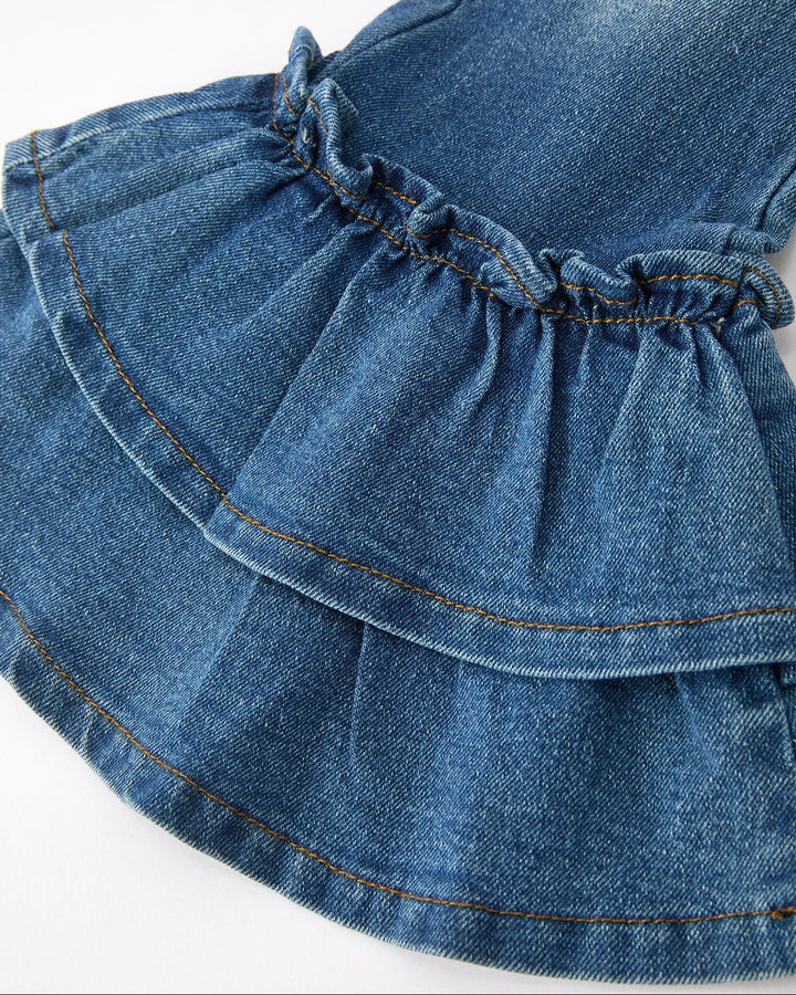 Close-up of girls denim ruffle bell hem with gathered elastic waistband