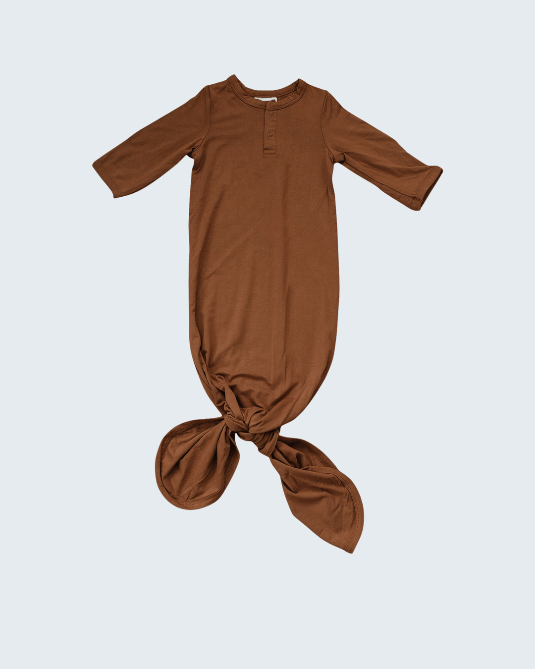 Brown baby knot gown on a light gray background