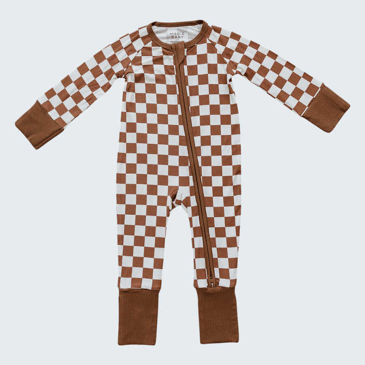 Checkered baby onesie with brown and white pattern on a light gray background