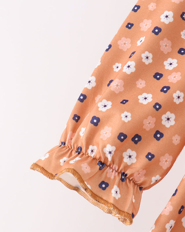 Rust floral pants leg with elastic cuff and gathered hem detail
