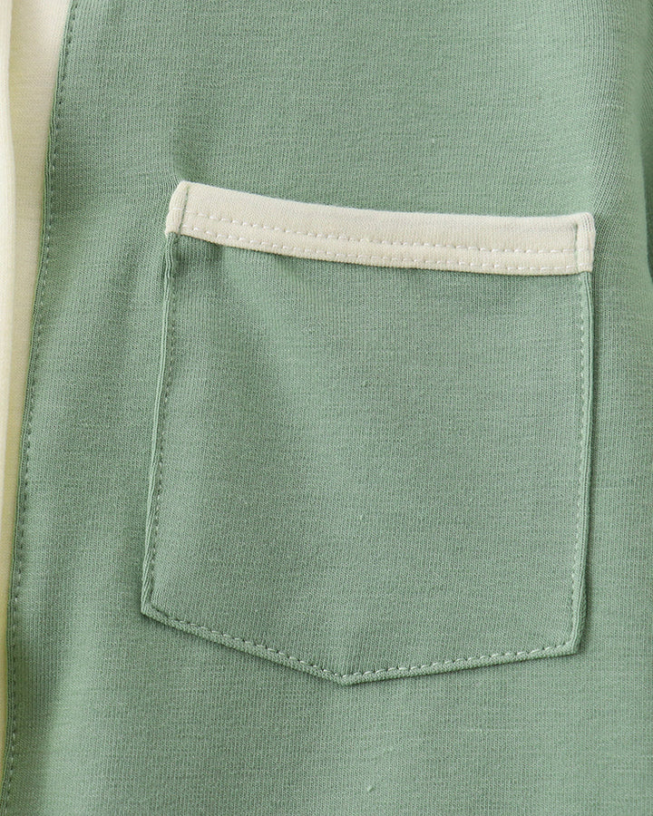 Sage green button-down shirt with chest pocket and cream trim.