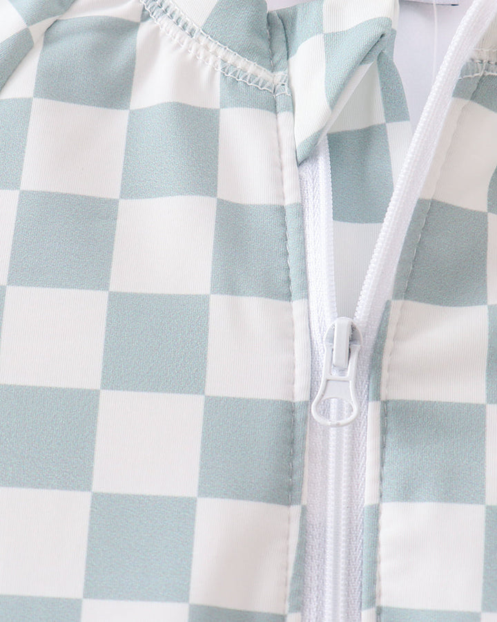 Checkered pattern with a zipper on a light blue and white background