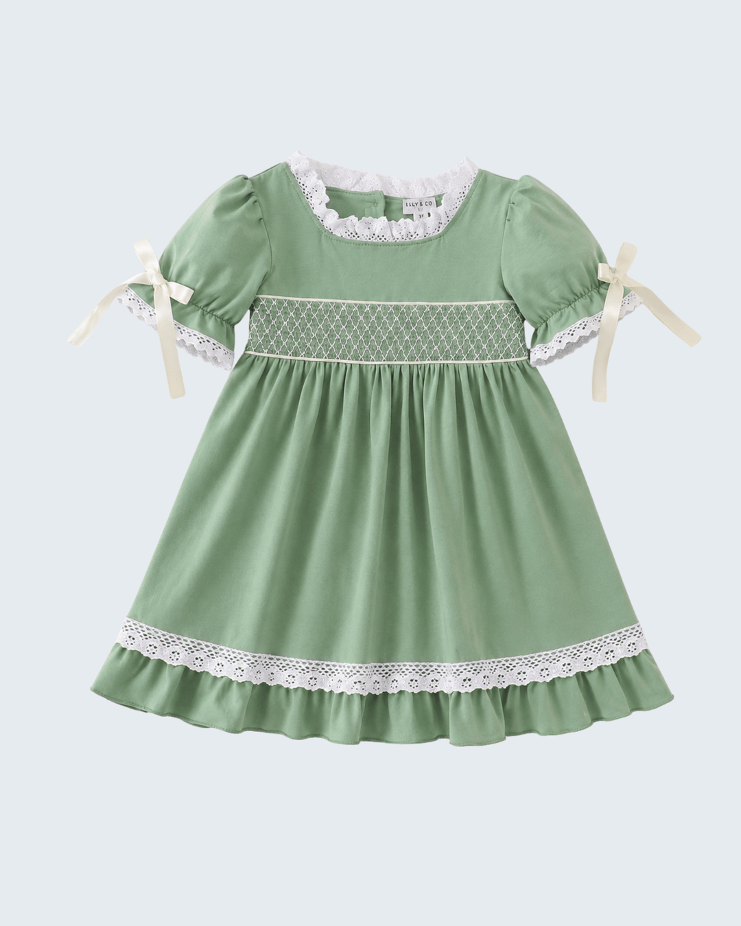 Sage green smocked dress with lace yoke, lace hem, and short puff sleeves with ribbon