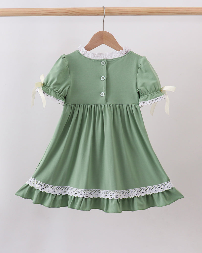 Sage green smocked lace dress with back buttons, puff sleeves, and lace hem