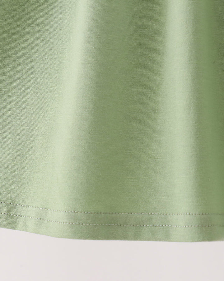 Sage green long-sleeve dress with embroidered deer faces and ruffle hem