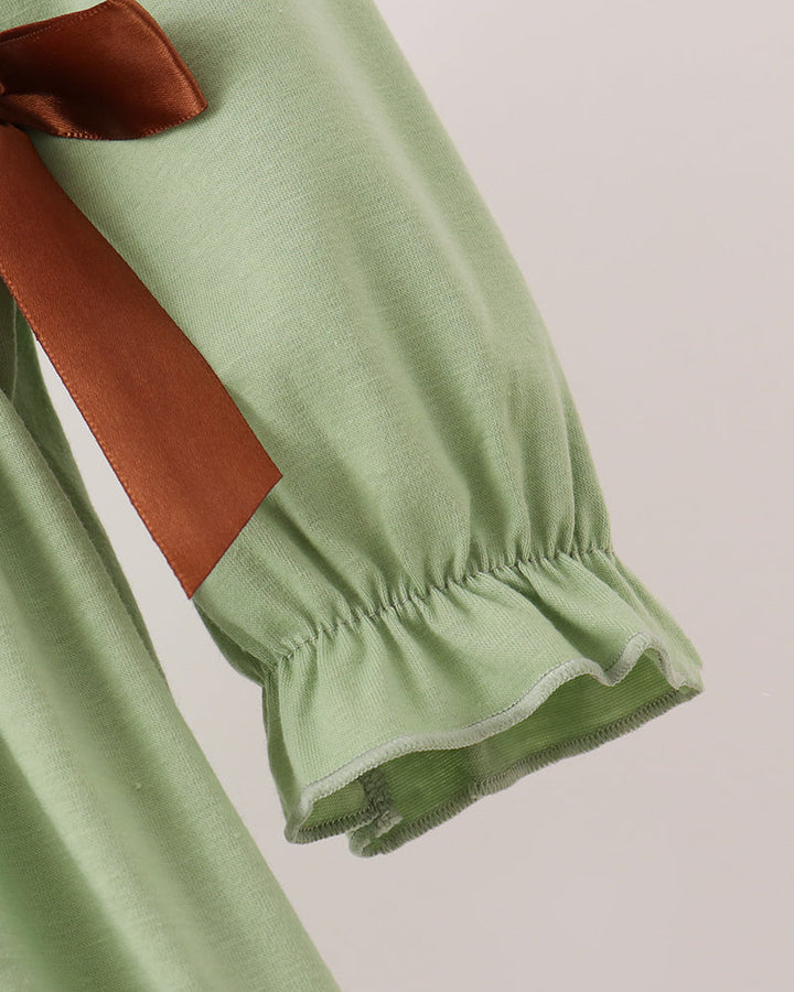 Sage green long sleeve with brown ribbon trim and elastic cuff