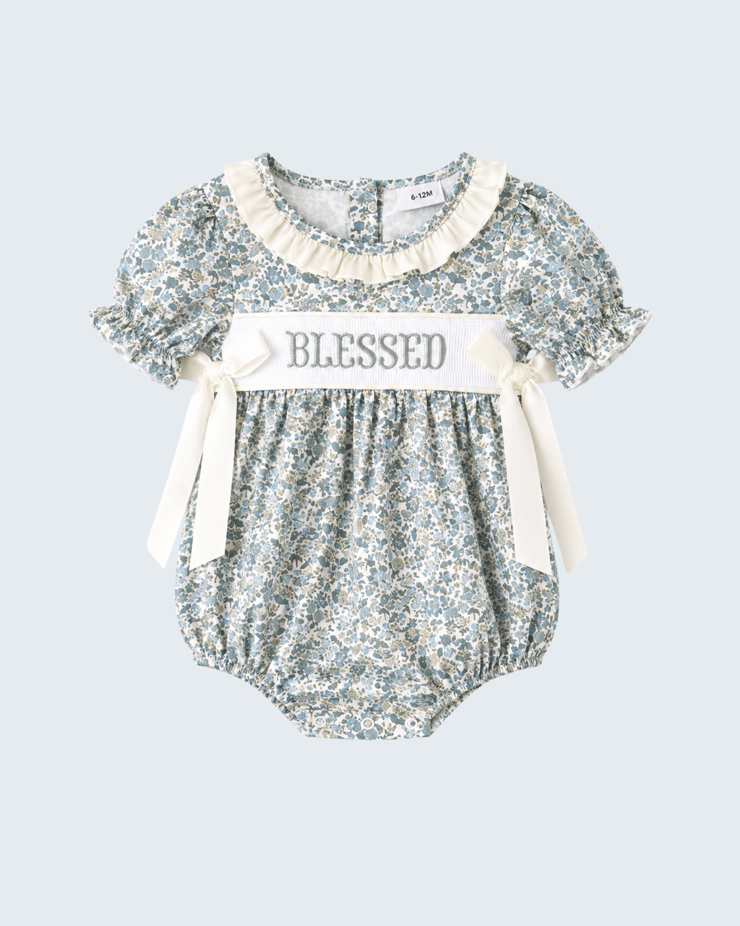 Blue floral bubble romper with "Blessed" applique, cream bow ties, flutter sleeves