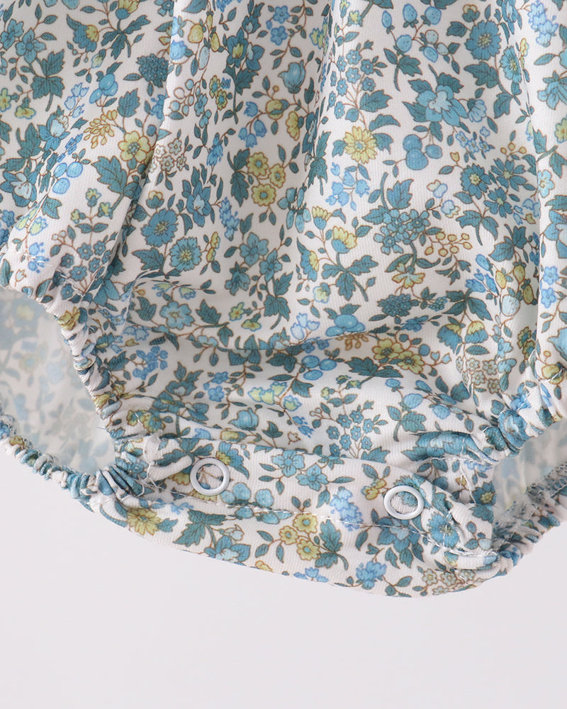 Blue floral bubble romper with ruffled leg openings and gathered fabric