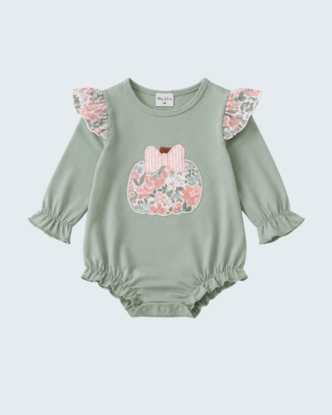 A baby long-sleeve romper in sage green, featuring ruffled floral-patterned sleeves and a matching floral applique chest design with a pink bow, shown on a light gray background.