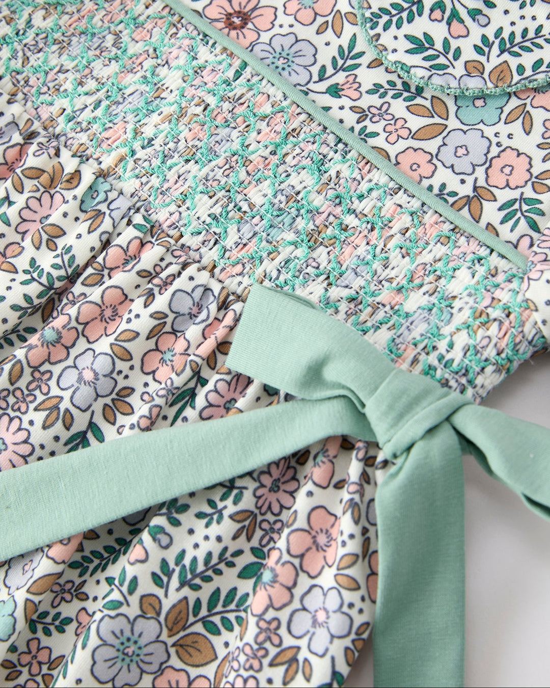 Floral smocked bodice with sage ribbon bow and gathered puff sleeves