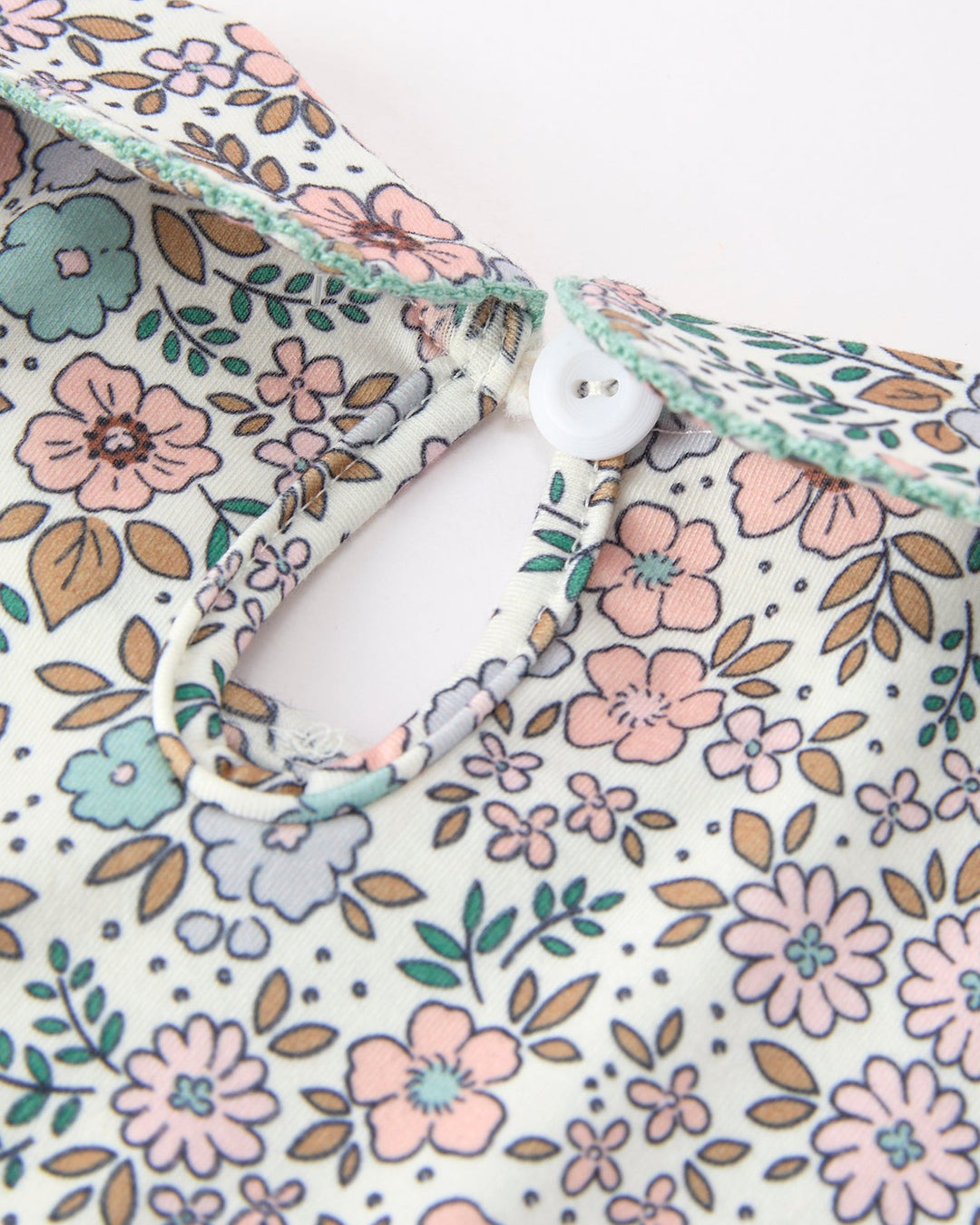 Floral girls top with keyhole back and white button, puff sleeve