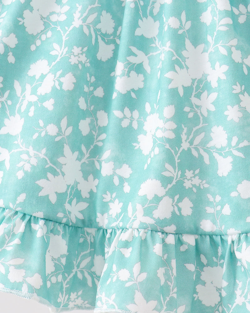 Floral patterned fabric with white flowers on a light blue background