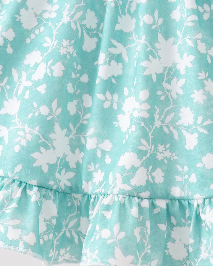 Floral patterned fabric with white flowers on a light blue background