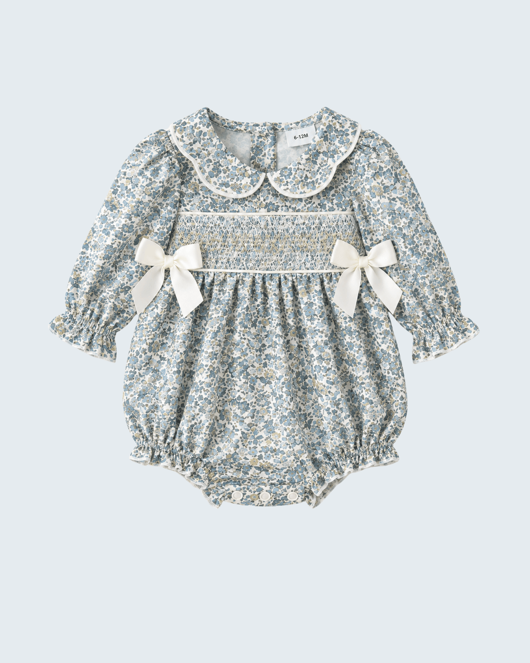 Floral smocked bubble romper with Peter Pan collar and twin shoulder bows