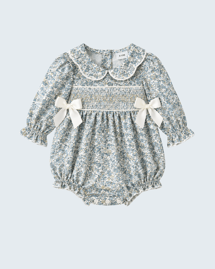 Floral smocked bubble romper with Peter Pan collar and twin shoulder bows