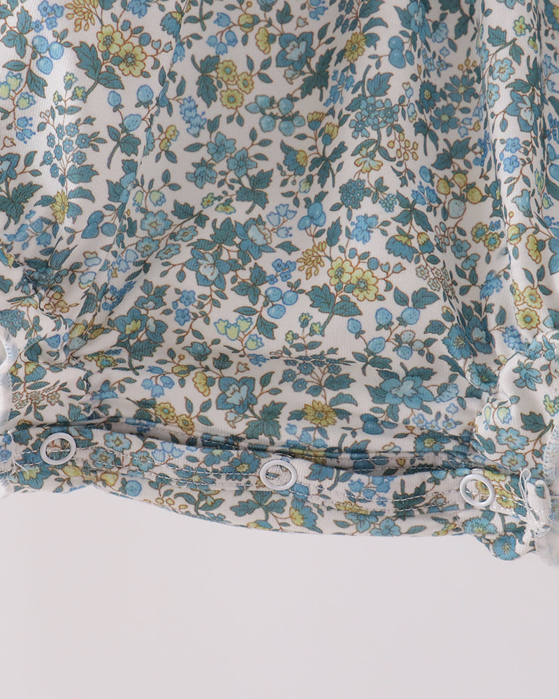 Blue floral smocked bubble romper with button front and ruffled hem