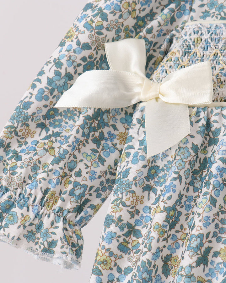 Smocked bubble romper with cream shoulder bows and gathered skirt