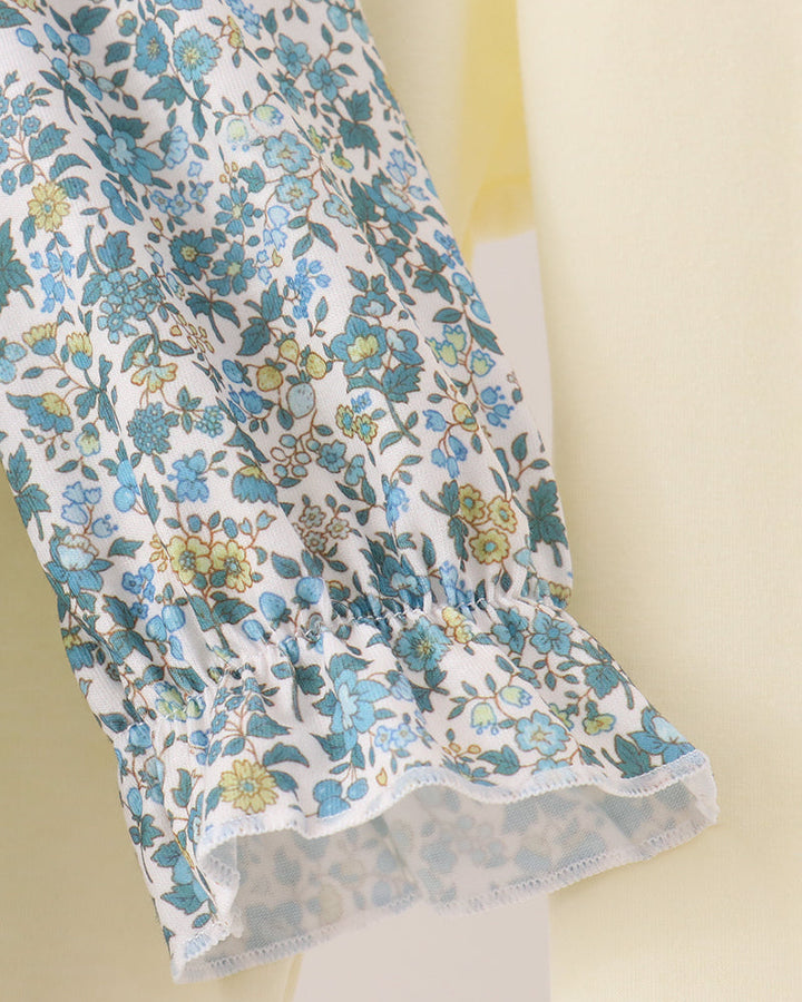 Floral tunic top hem with ruffled trim and elastic gathering at the waist