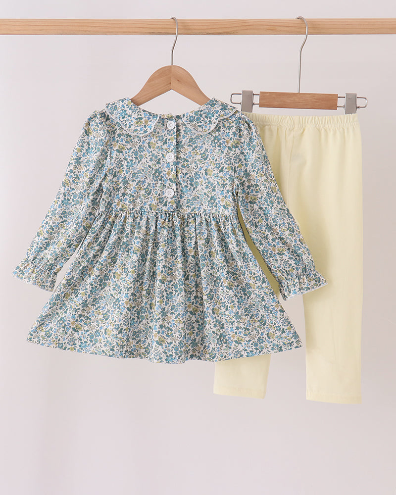 Floral smocked tunic top set with solid cream leggings, both on hangers