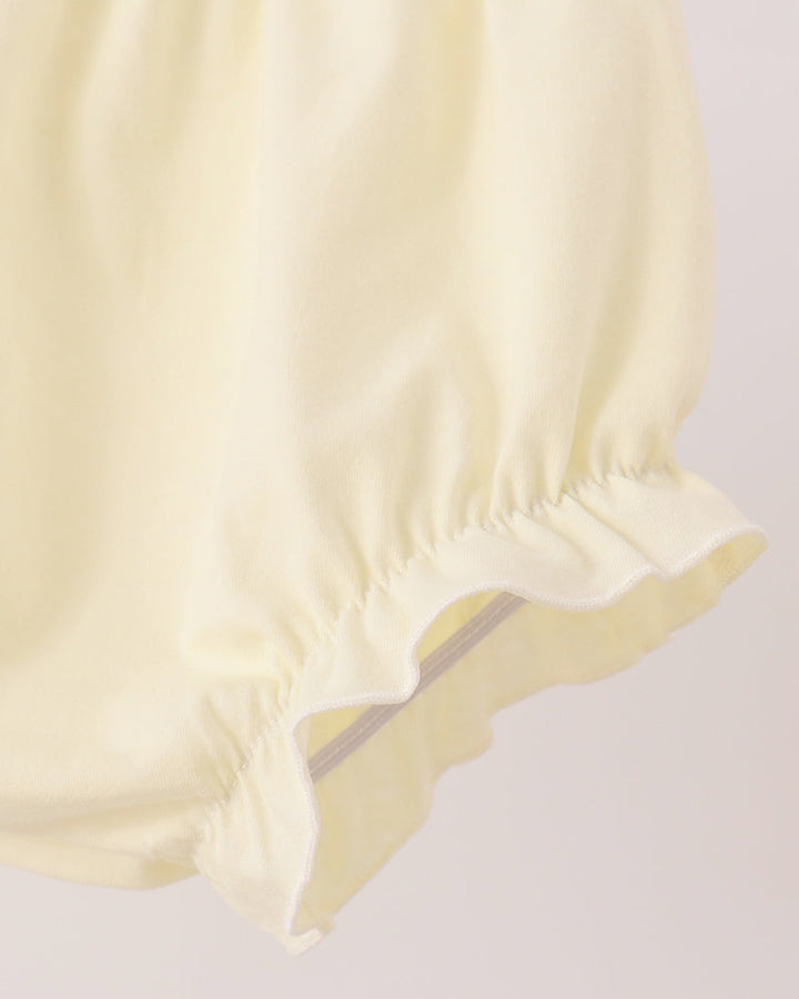 Light yellow baby bloomer shorts with ruffled hem