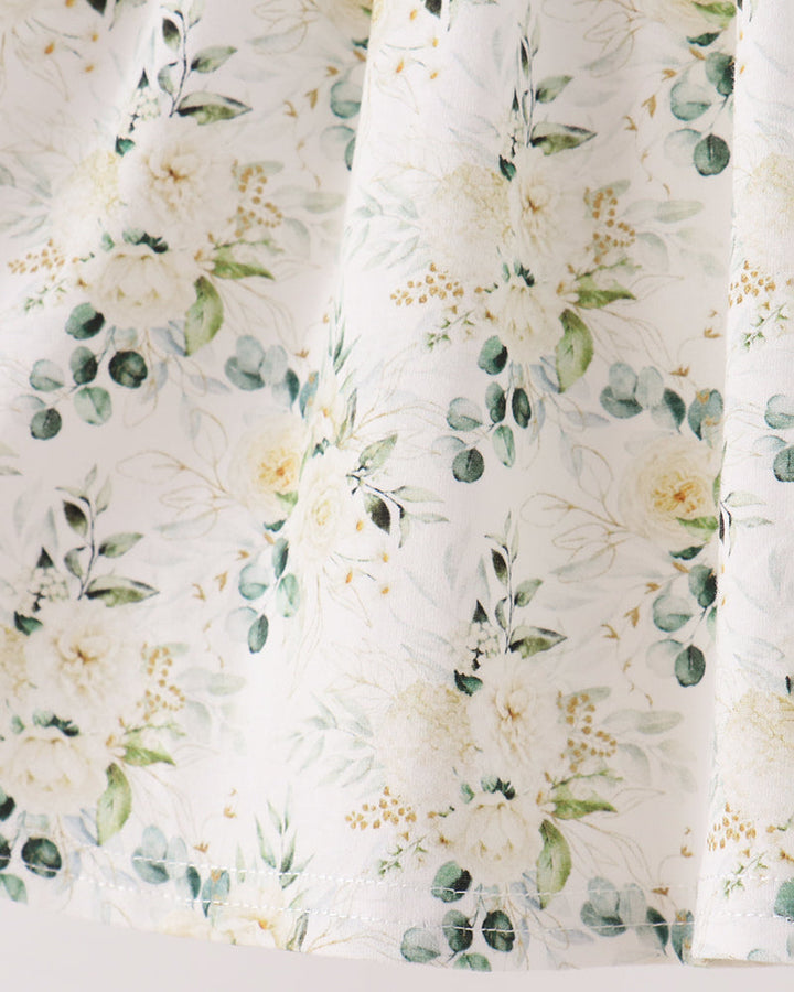 Floral ruffle pants leg in white fabric with sage, yellow and green blooms