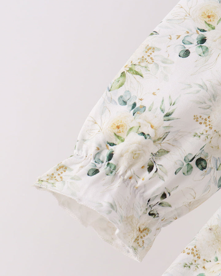 White floral ruffled cuff with gathered detail on the long sleeve top