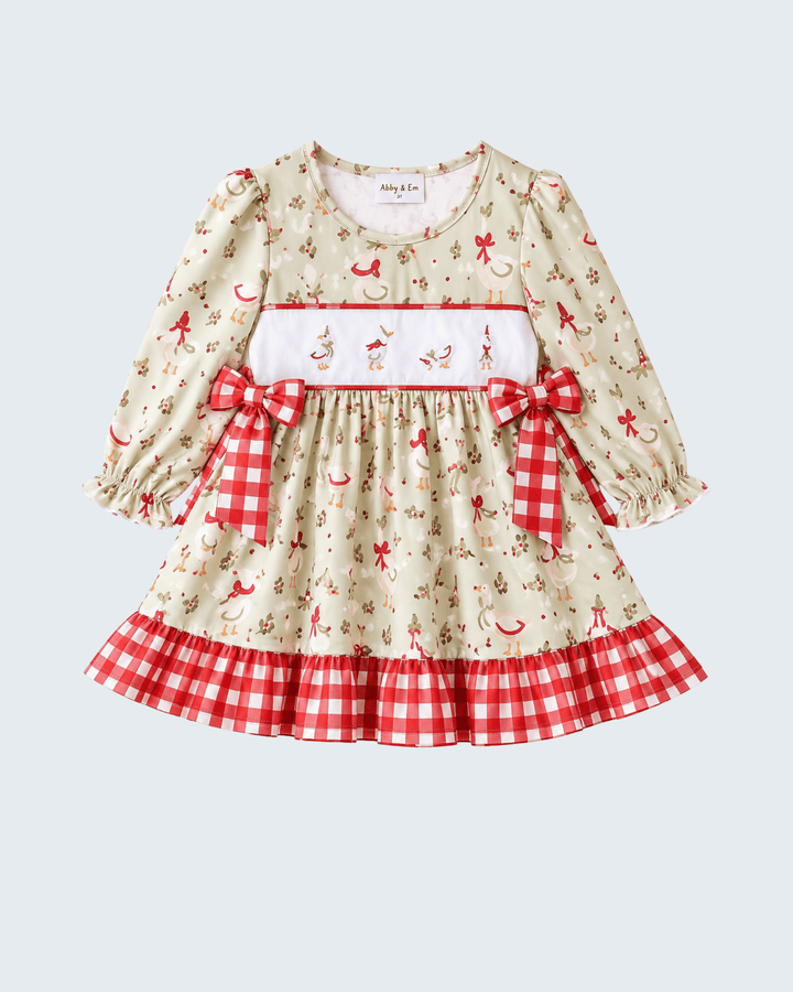 Cream embroidered dress with red bow detailing, gathered skirt, and red gingham hem