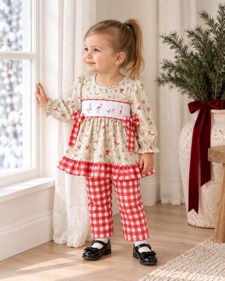 Kids wearing cream ruffle printed top with red gingham pants and tied bow