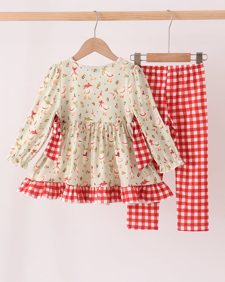Kids printed ruffle top and red gingham pants set hanging together