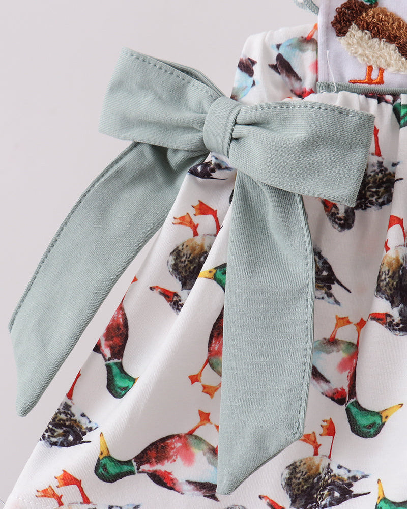 Animal-print dress with sage neck tie bow and sage long-sleeve cuffs