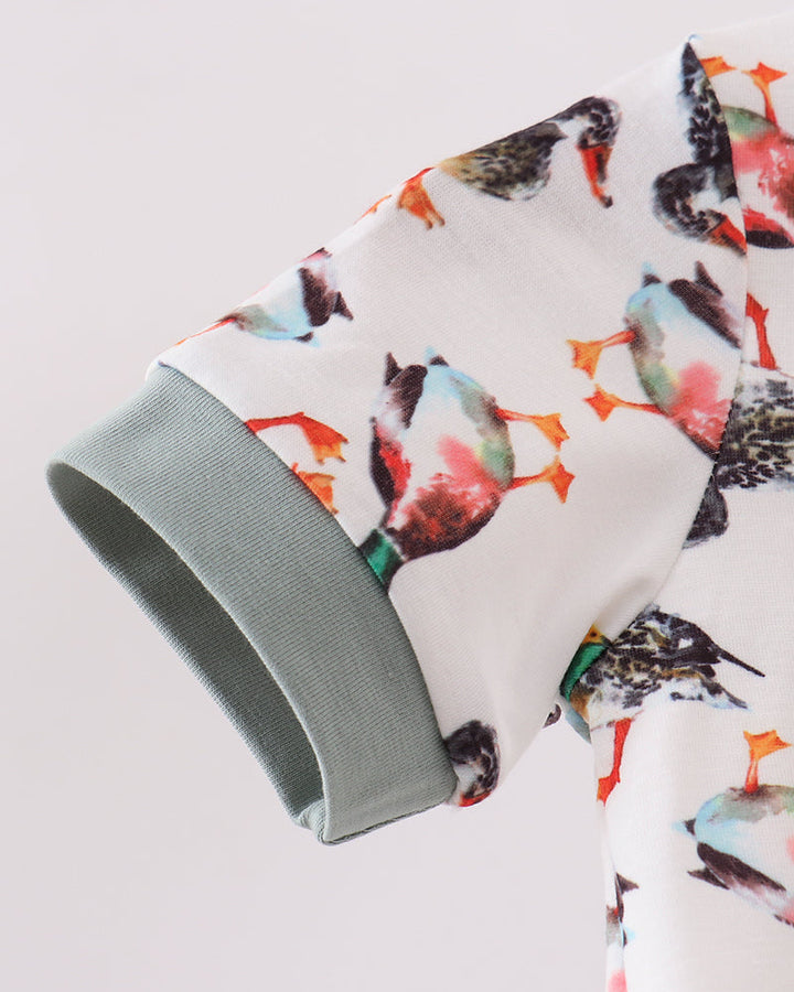 White bird-print baby romper sleeve with sage green cuff