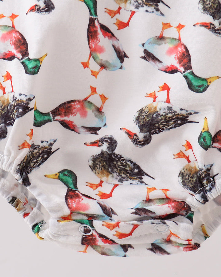 White bubble romper with gathered hem and multicolor bird print